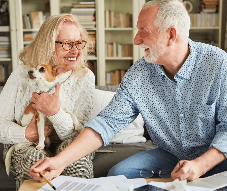 April 25 Events Page Image - The Summit of Citrus Hills Elderly man and woman smiling and holding small dog