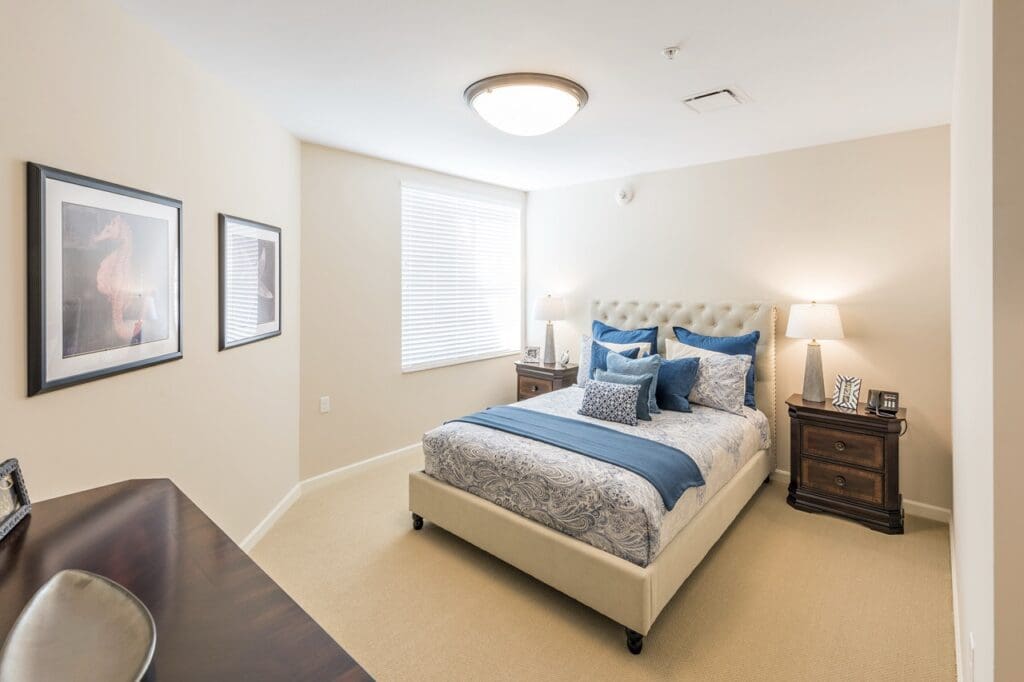 Interior image of a resident's bedroom with comfortable furniture and natural lighting.